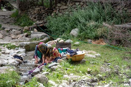 Unidentified Women are washing clothes at Turtuk village