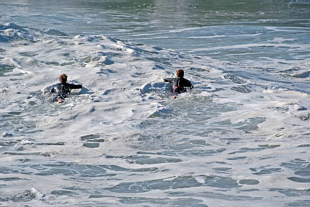 istock Two surfers paddling out to surf 183695197