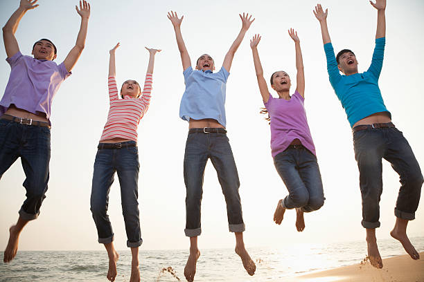 istock Group of Friends Jumping at the Beach 183695622