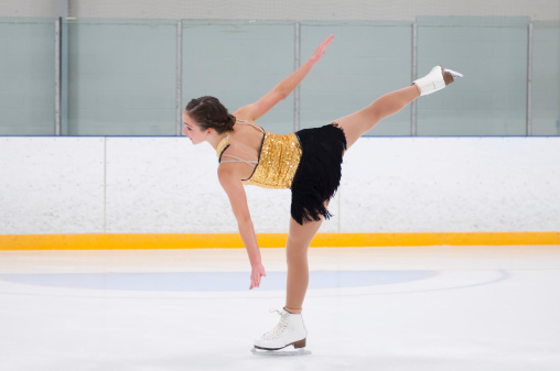 Figure skater gliding on one leg.