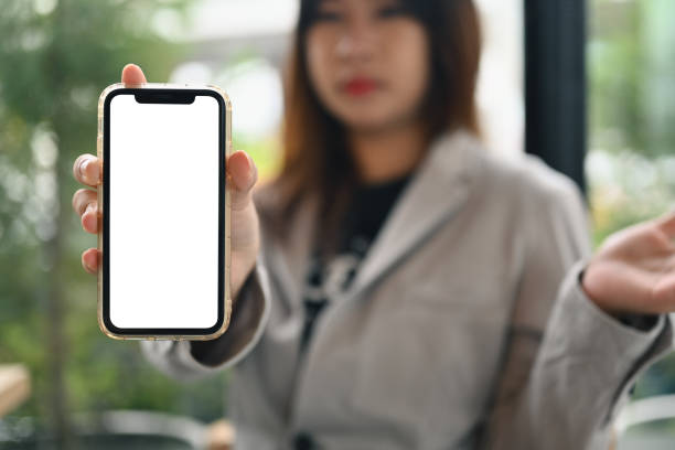 istock Young woman showing mobile phone with empty white screen for recommending mobile application 1836978988