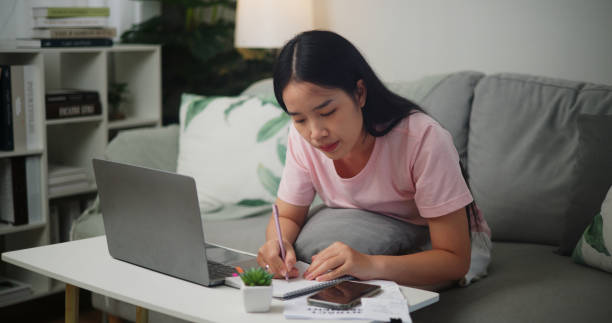 istock Young Asian woman planning budget and using calculator on smartphone 1836981661