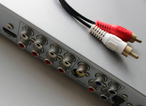 istock Audio cable with two colored RCA plugs is on the top panel of DVD player 1836984856
