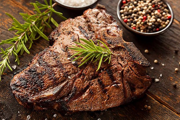 Grilled BBQ T-Bone Steak Grilled BBQ T-Bone Steak with Fresh Rosemary porterhouse steak stock pictures, royalty-free photos & images