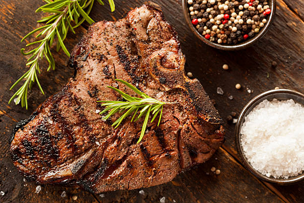 Grilled BBQ T-Bone Steak Grilled BBQ T-Bone Steak with Fresh Rosemary porterhouse steak stock pictures, royalty-free photos & images