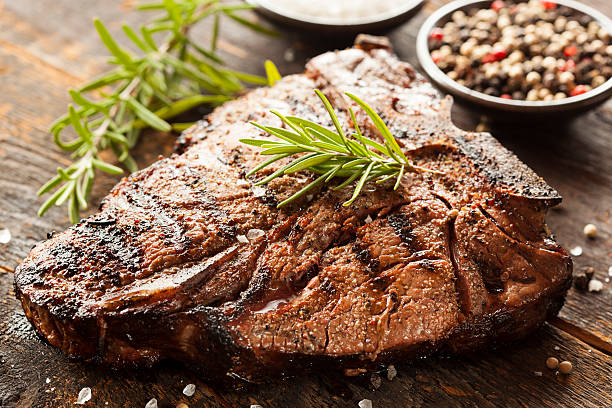 Grilled BBQ T-Bone Steak Grilled BBQ T-Bone Steak with Fresh Rosemary porterhouse steak stock pictures, royalty-free photos & images