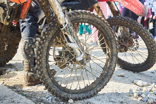 Motorsport, motorcycle wheel in the mud. Mountain motorcycling. Adventures on the track
