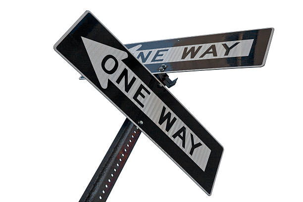 dos señales en una manera apuntando en diferentes direcciones - conflict one way sign road sign fotografías e imágenes de stock