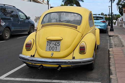 Corralejo, Fuerteventura, Spain, November 24, 2023 - An old yellow Volkswagen Beetle (VW 1300) from 1968