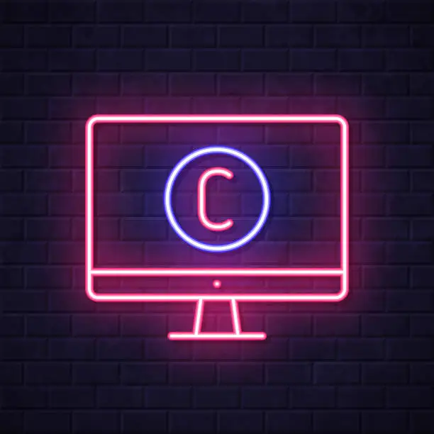 Vector illustration of Desktop computer with copyright symbol. Glowing neon icon on brick wall background