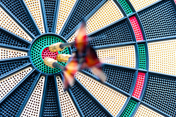 Blurred darts stuck in bulls-eye