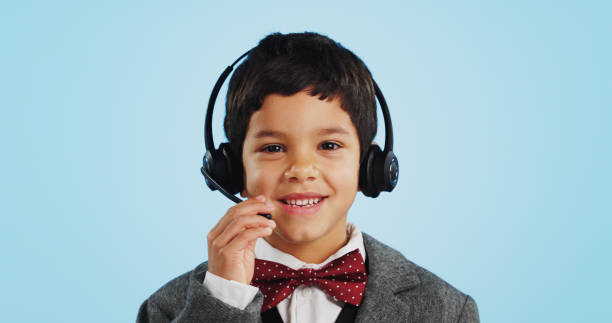istock Face, studio or child consultant in call center talking or networking for telecom on blue background. Young, contact or friendly kid sales agent in communication or conversation at customer service 1837041833
