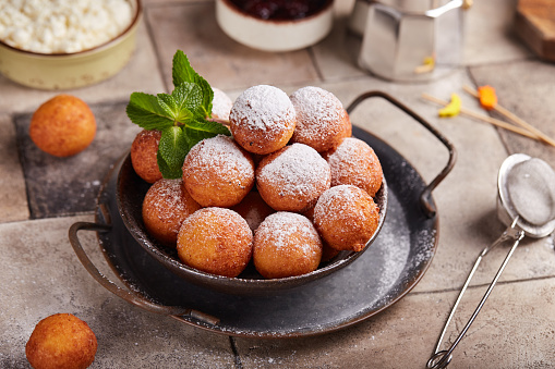 Deep fried cottage cheese balls or donuts. Freshly baked sweet croquettes, served sugar powder. Delicious homemade dessert.