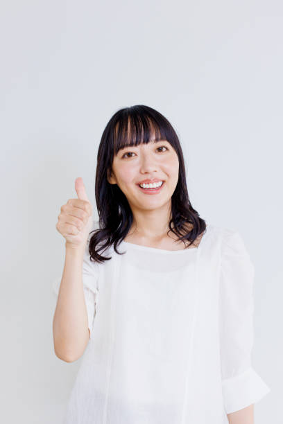 istock Asian woman with thumbs up gesture 1837051369