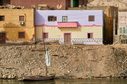 aswa, Egypt – September 26, 2023: A small Egyptian town near the city of Aswan,with colorful houses built on the banks of the Nile River