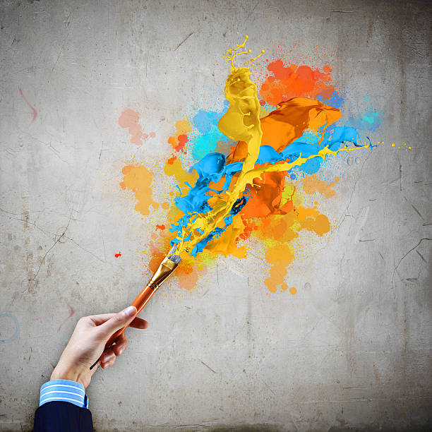 istock Human hand holding paint brush 183705960
