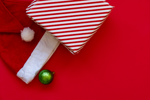 Christmas composition. Gift box, Christmas decorations on red background