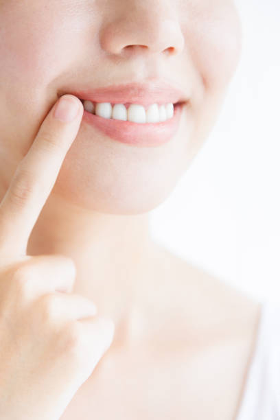 istock Young Asian woman smiling and showing her teeth 1837083328