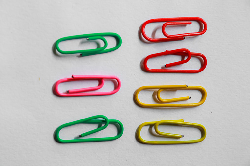 colorful paper clips isolated on white