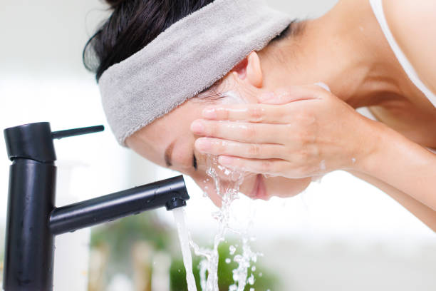 istock Young Asian woman washing her face 1837086426