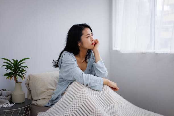 istock Young Asian woman feeling depressed in her bed 1837089022