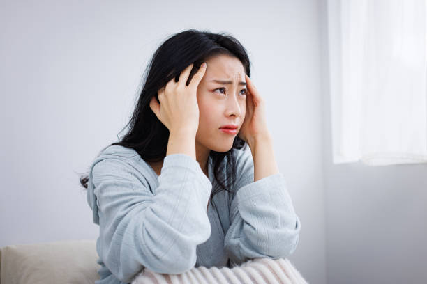 istock Young Asian woman in her bed suffering from headache 1837089539
