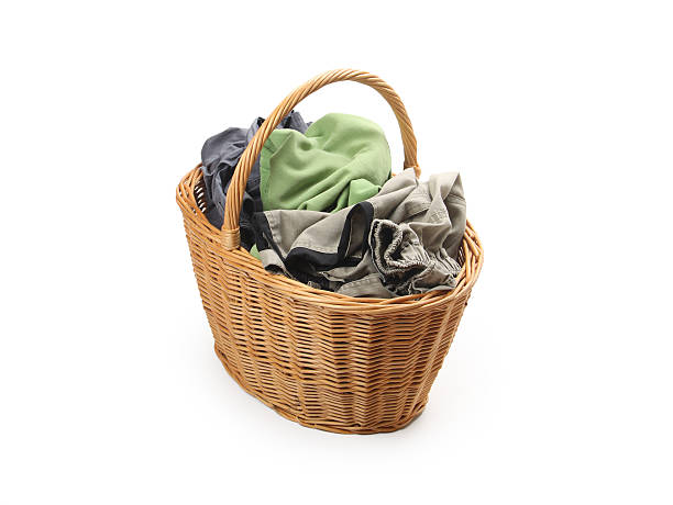 istock laundry in wicker basket, isolated on white 183709065
