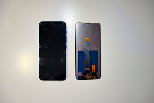 Replacing the screen on a mobile phone. A broken smartphone screen.