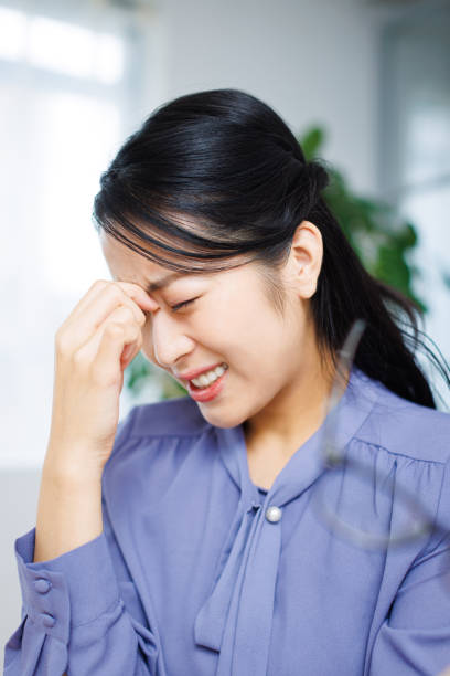 istock Young Asian woman having headache while working at home 1837101083