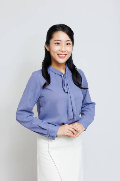 istock Young Asian woman in semi formal attire posing for camera 1837103163