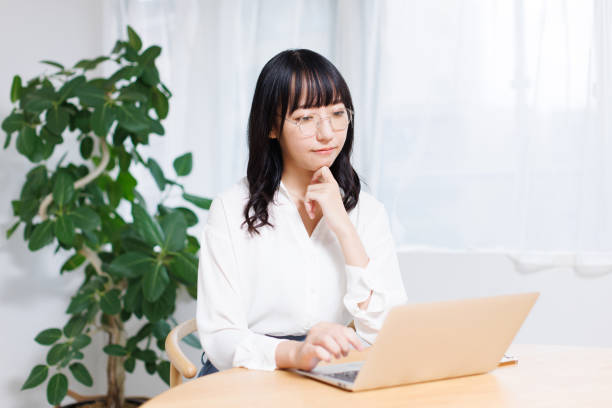istock Young Asian woman contemplating while working at home 1837110190