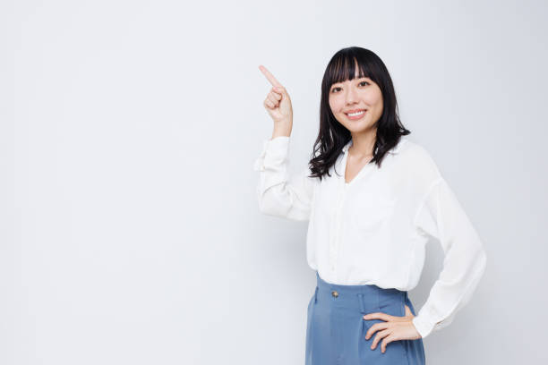 istock Young Asian woman with pointing gesture 1837114465