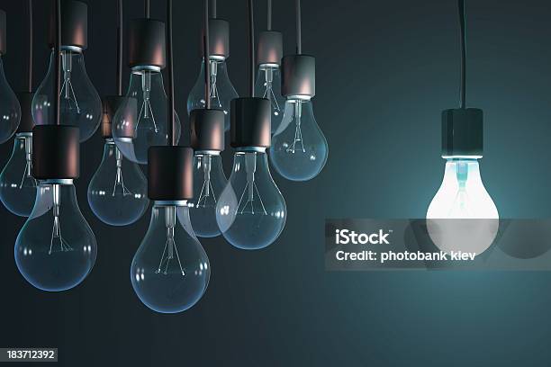 Glowing Bulb Among The Gray Stock Photo - Download Image Now - Intellectual Property, Light Bulb, Standing Out From The Crowd