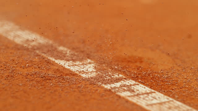 Super slow motion of Tennis ball ping on clay court