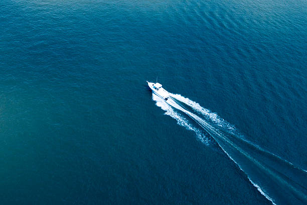 Aerial View of Boating on the Hudson River Spectacular aerial view of a boat speeding on the Hudson River. wake water stock pictures, royalty-free photos & images