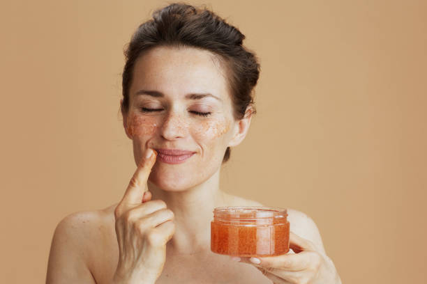istock relaxed modern woman with face scrub isolated on beige 1837148465