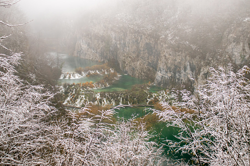Plitvice lakes (Plitvička jezera) in winter time wrapped with fog and snow