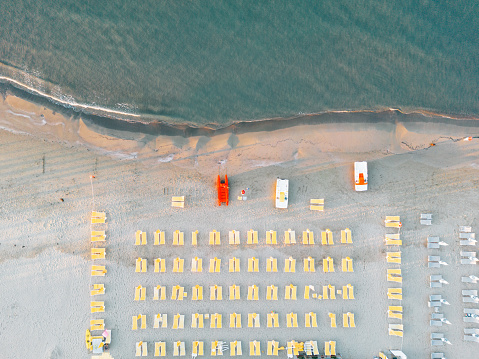 Aerial view of a beach with many deck chairs. Italian beach in summer.