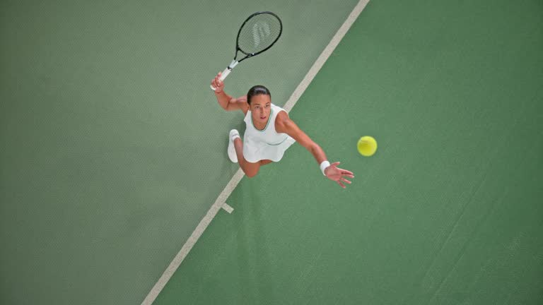 SLO MO LD Above a female tennis player serving