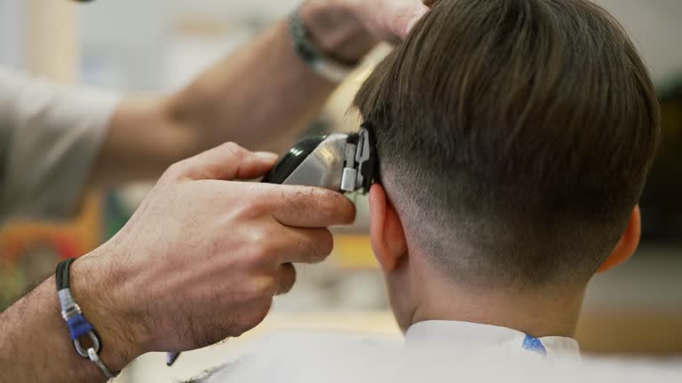 Little kid having a haircut at the barber