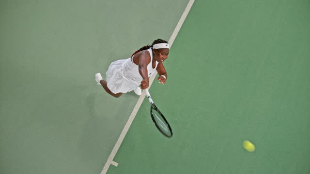 SLO MO LD Right above a female tennis player serving