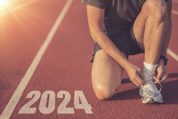 istock young man runner tying shoelace on running track with numbers 2024 1837244649