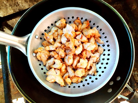 Deep fried Chicken Meat in cooking pan - food preparation.