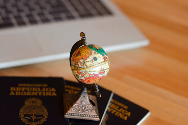 istock earth globe and Argentina passport with notebook in the background 1837254805