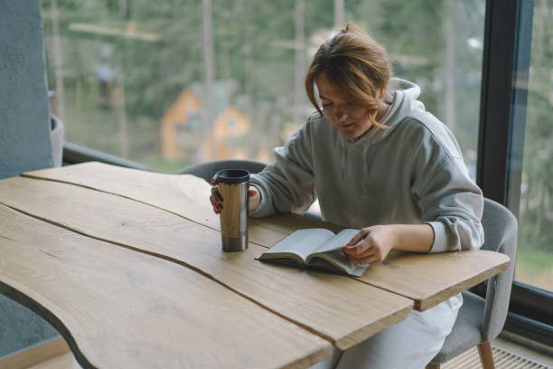 istock A Woman reads the book and drinks coffee 1837271272
