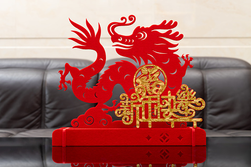 Chinese New Year of Dragon mascot paper cut in a living room English translation of the Chinese words are fortune and happy Chinese new year no logo no trademark