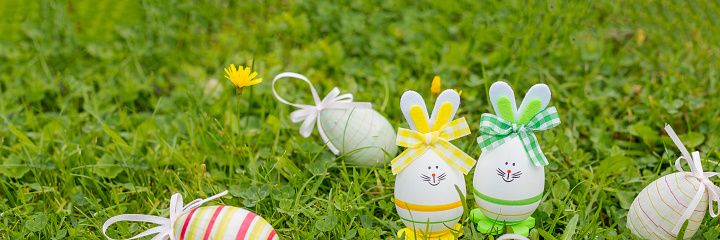 Easter object. colored hand painted easter eggs and decorative rabbits are symbols of the holiday. composition on a light background