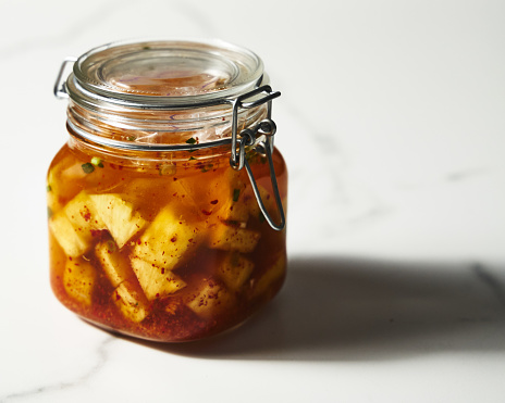 Fermented Pineapple kimchi. With garlic, gochugaru pepper and fish sauce. Pickled pineapple. High quality photo
