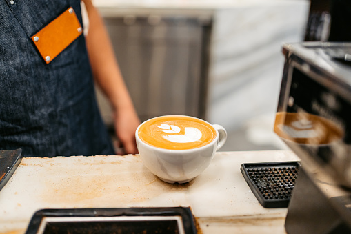 A cup of cappuccino on a bar counter in a coffee shop in Kuwait City in Kuwait.