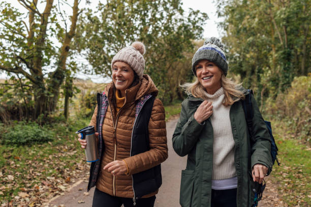 istock Two Friends Walking Through the Countryside Together 1837326024